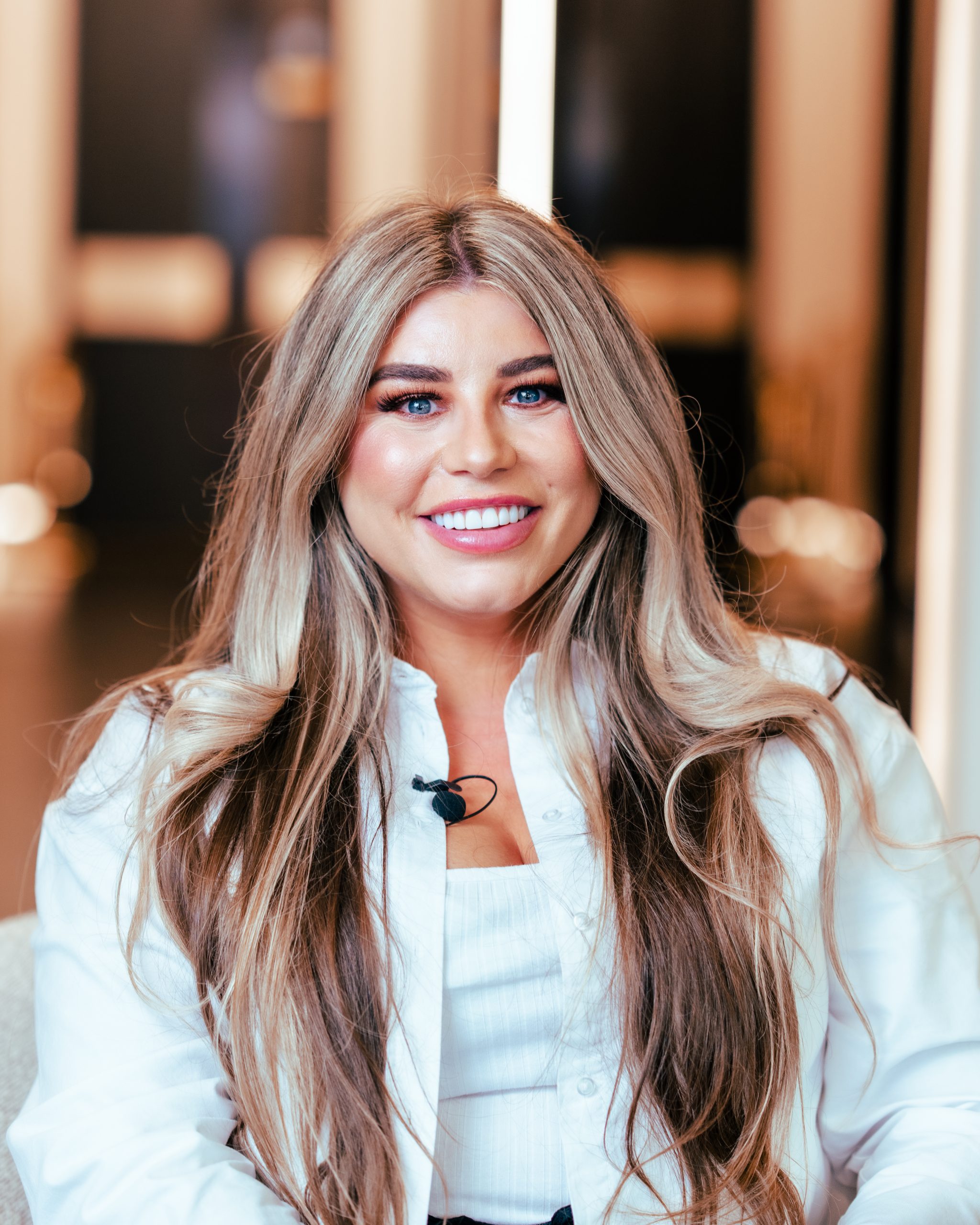 Dental clinic Practice Manager Brodie Galvin-Noon smiling while wearing all white