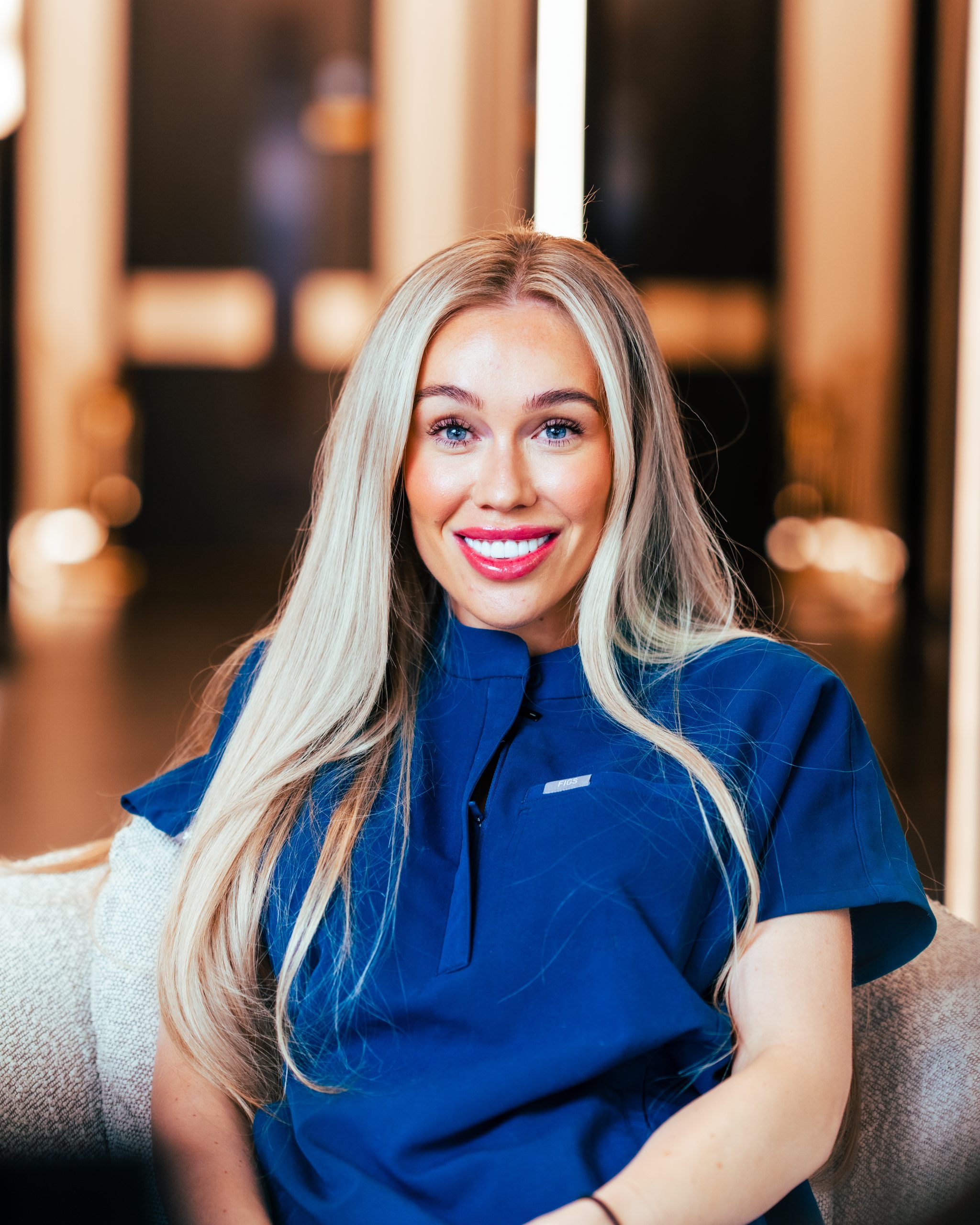 Dental Nurse Morgan Smith smiling while wearing dark blue scrubs