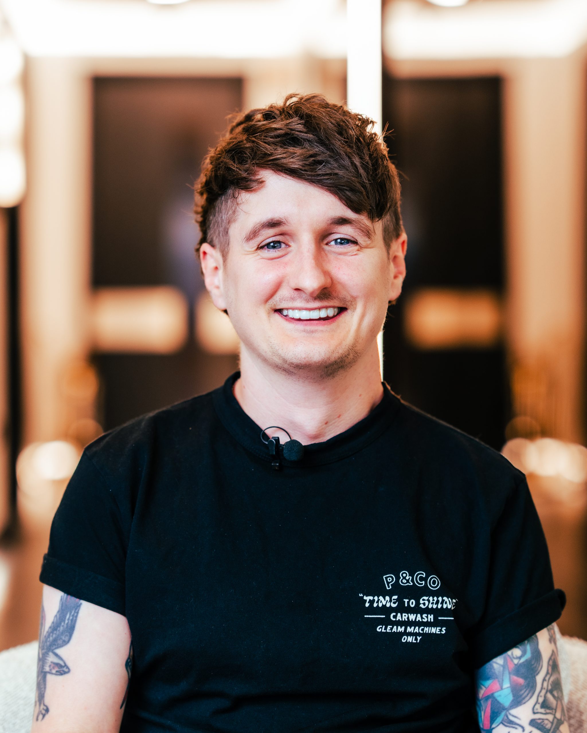 Headshot of Dental Therapist Tim Forshaw looking happy wearing a black t-shirt