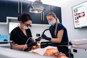 A dentist and dental nurse during composite veneers treatment